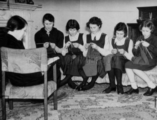 'A family knitting circle'  7 February 1940