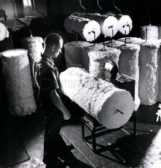 Mill worker with rolls of carpet material  Bolton  1956.