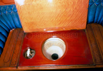 Wooden commode with decorated bowl in Queen