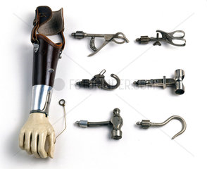 Artificial arm with attachments  c 1921-1930.