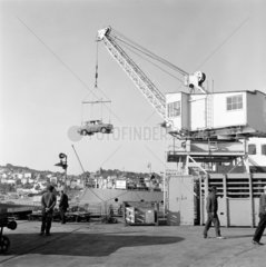 Cars being loaded onto a ship at a harbour on Guernsey  6 October 1971.