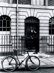 Postman delivering a telegram to an address in London  c 1930s.