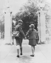 Two school children walking hand in hand  26 August 1960.