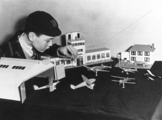 Boy playing with model aeroplanes.