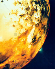 Io  one of the moons of Jupiter  showing a volcanic eruption on the horizon  1979.