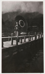 Japanese woman on a bridge  c 1925.