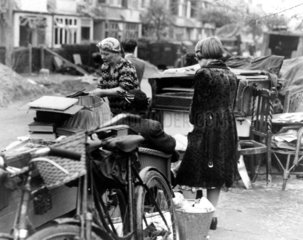 Women with their belongings after an air raid  19 September 1944.