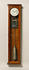 Electric master clock of the half minute impulse type in mahogany case  c 1931.