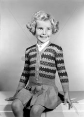 Little girl in a knitted cardigan  c 1950.