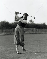Smoking golfer caught in mid-swing  c 1930s