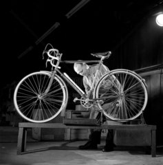A worker at the British Cycle Company inspects a finished item  1958.