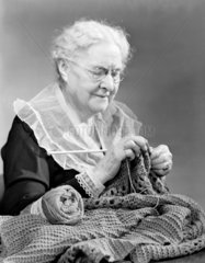 Elderly woman knitting  1949.