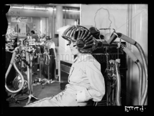 Woman sitting under a hairdryer  9 September 1934.
