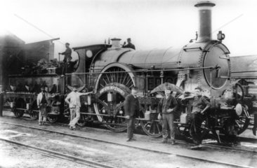 ‘Iron Duke' steam locomotive with railway workers  c 1880s.