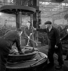 Three men working on locomotive wheels  Swindon  1948.