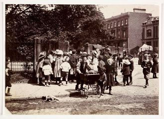 Children gather near a park  c 1900.