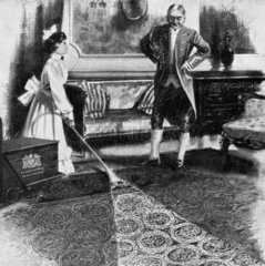 Maid vacuum cleaning a carpet while a manservant looks on  1911.