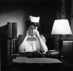A student nurse reads in her digs at the Royal Free Hospital  1958.