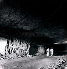 Two miners walk through a seam at a gypsum mine  Brightling  1974.