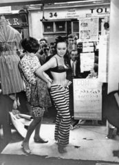 Dressing a model in the window of a boutique  13 May 1966.
