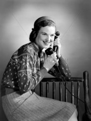 Woman talking on the telephone  c 1950.
