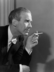 Man smoking a cigarette  1950