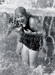 Teenage girls playing in a fountain  c 1930