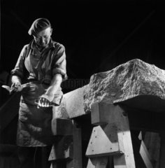 A mason at Shap Granite marks out a slab of stone with chisel  1961.