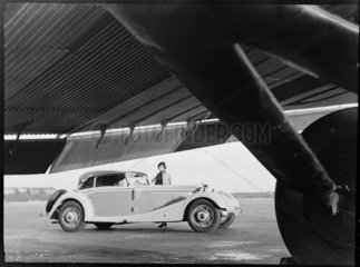 Mercedes-Benz convertible under the wing of a Junkers plane  1930s.