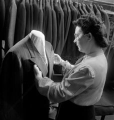 Female clothing worker inspecting Jacket   1948.