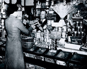 Woman buying groceries  24 June 1937.