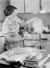 Woman admiring laundry  1950.