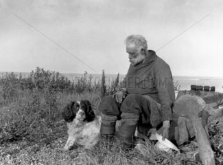 Fisherman and his dog  c 1910s.