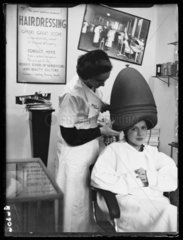 Woman sitting under a hairdryer  1938.