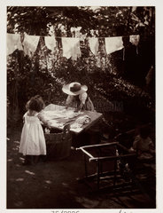 Children doing the laundry  c 1905.