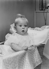 Baby in a cot  1956