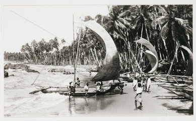 Boats on a tropical beach  c 1925.
