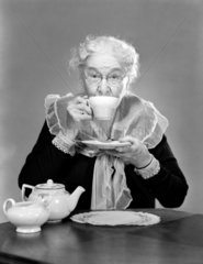 Elderly woman drinking tea  c 1955.