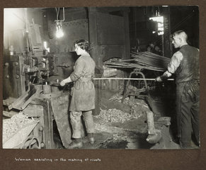 'Woman assisting in the making of rivets'  1915-1918.