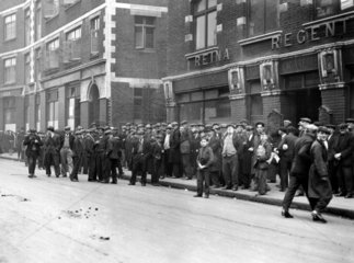 Unemployed men queuing at a labour exchange