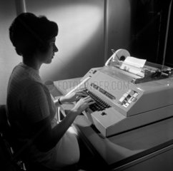 Female typist at work testing the Envoy telex machine  1967.