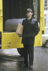 Rail freight employee holding a parcel  April 1964.