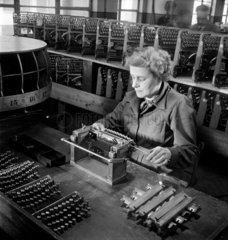 A female worker inserts typewriter keys  in to main frame Leicester  1951.