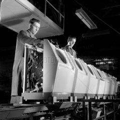 Men fit casings to a line of Hoovermatic washing machines  1961.