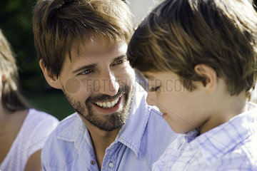 Father and son talking together outdoors
