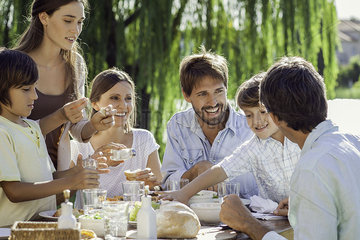 Family enjoying breakfast together outdoors