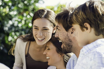 Family laughing together outdoors