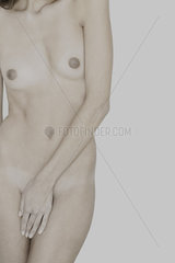 Nude woman covering groin with hand  cropped