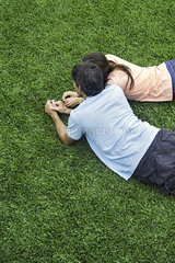 Couple lying together on grass