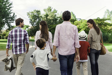 Family walking together outdoors  rear view